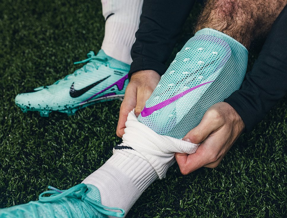Football Shinpads on-pitch featuring Nike Mercurial Lite model in Turquoise